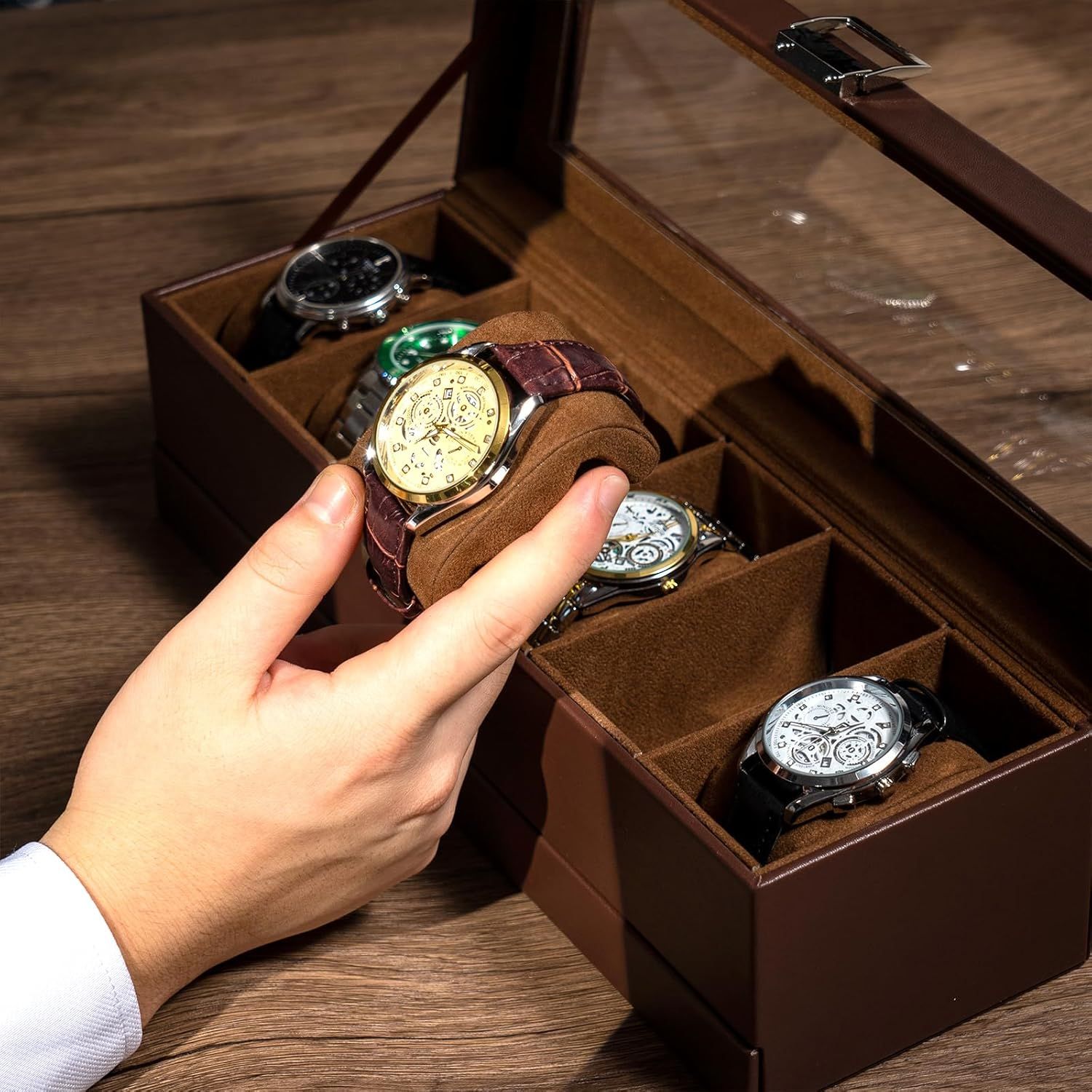 Demonstrates the premium storage solution included with the product, showcasing how multiple watches can be organized and displayed in individual compartments with protective cushions.
