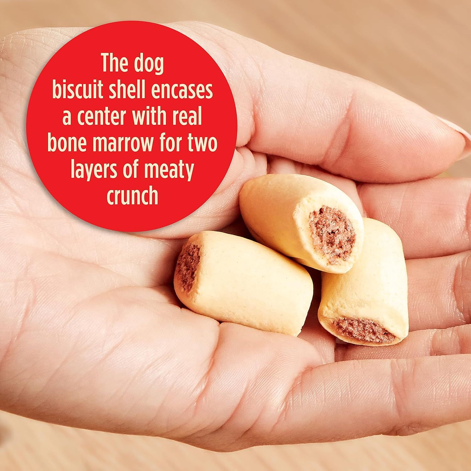 Explains the internal structure of the dog biscuit, highlighting the real bone marrow center and two layers of meaty crunch to communicate quality ingredients and appeal to pet owners.
