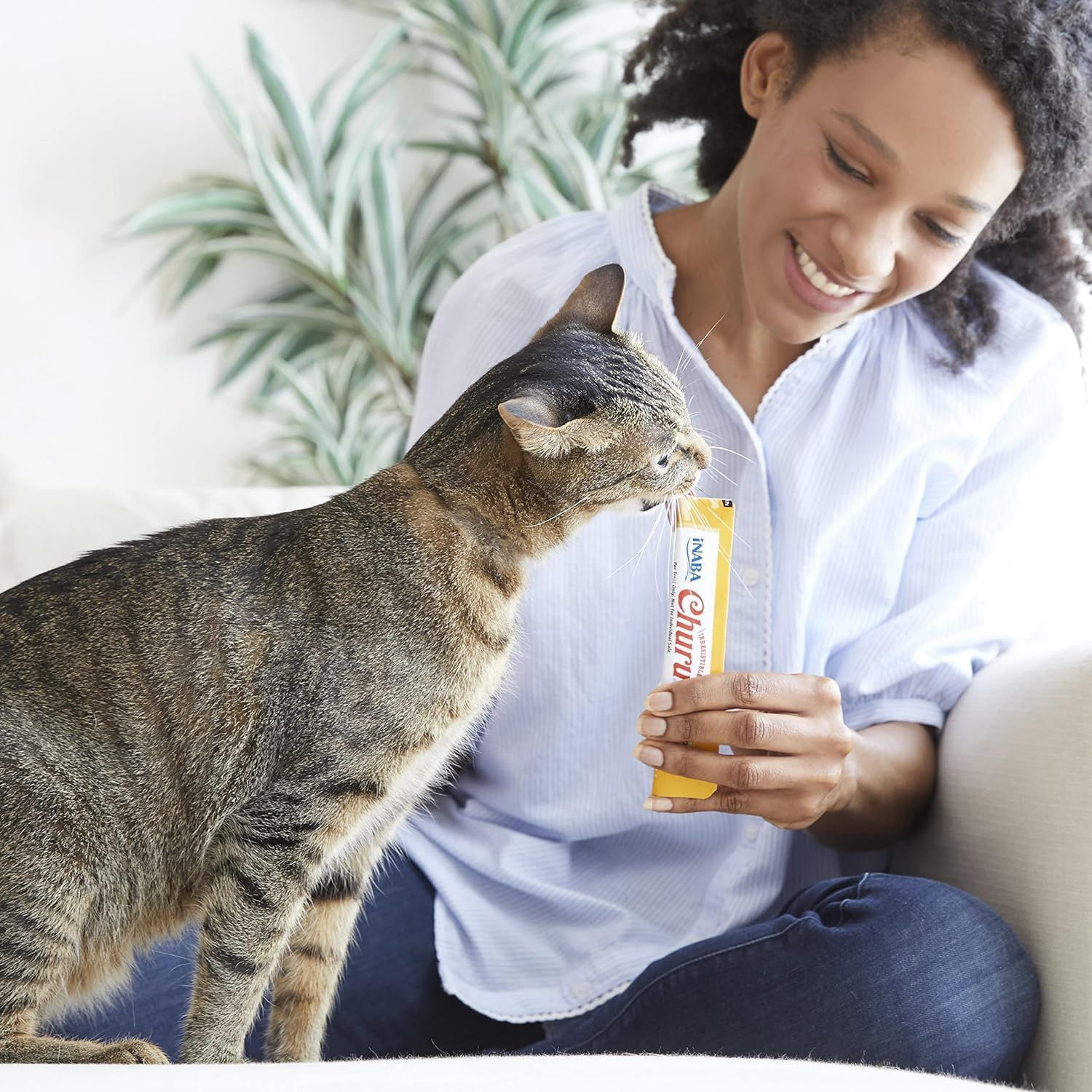 Demonstrates the product being used in a real-world home setting with a cat to create emotional connection and show natural product interaction.