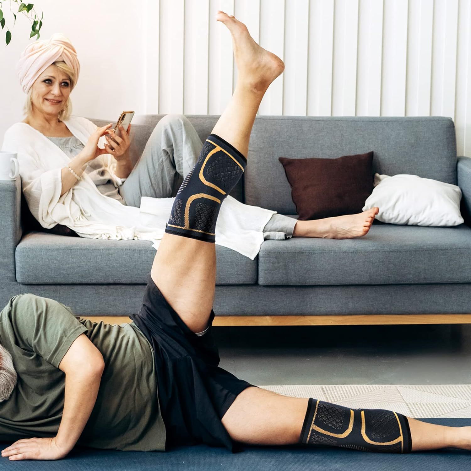 Demonstrates the product being worn comfortably in a real-world home environment, showing that the knee and leg support sleeves fit naturally into everyday relaxation and lifestyle activities.