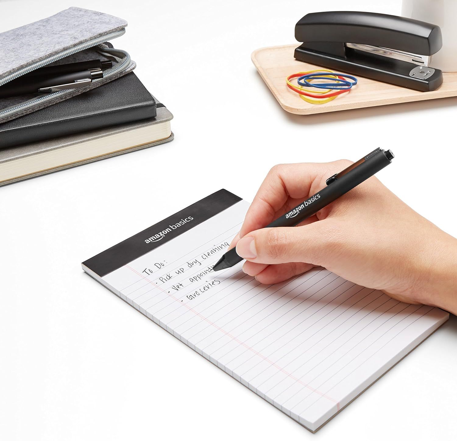 Demonstrates the product in a real-world office setting to help shoppers visualize how the AmazonBasics stationery items fit into their daily work routine.