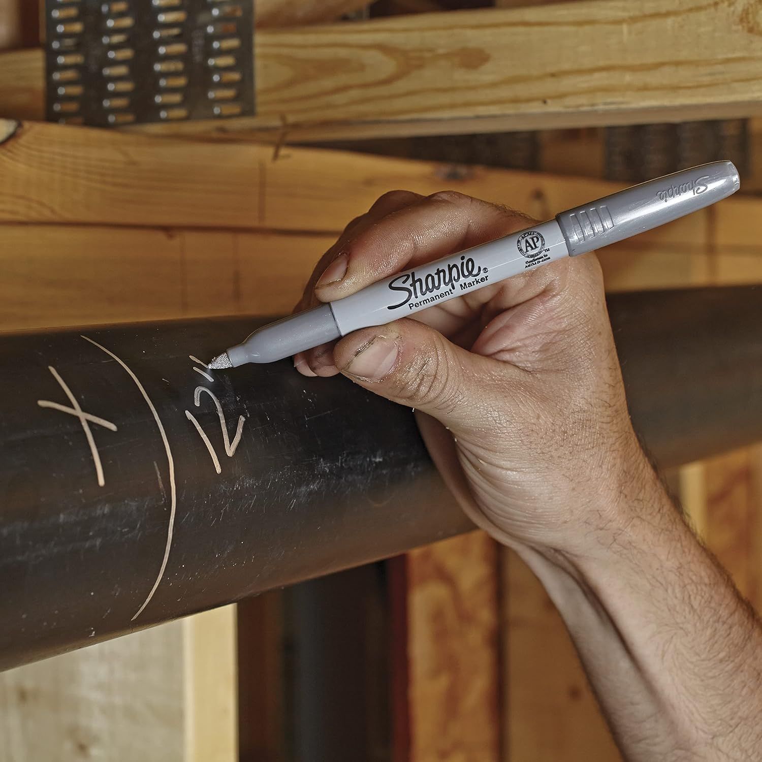 Demonstrates the product being used in a real-world setting to help shoppers visualize how they would use the Sharpie marker in their own projects or daily tasks.