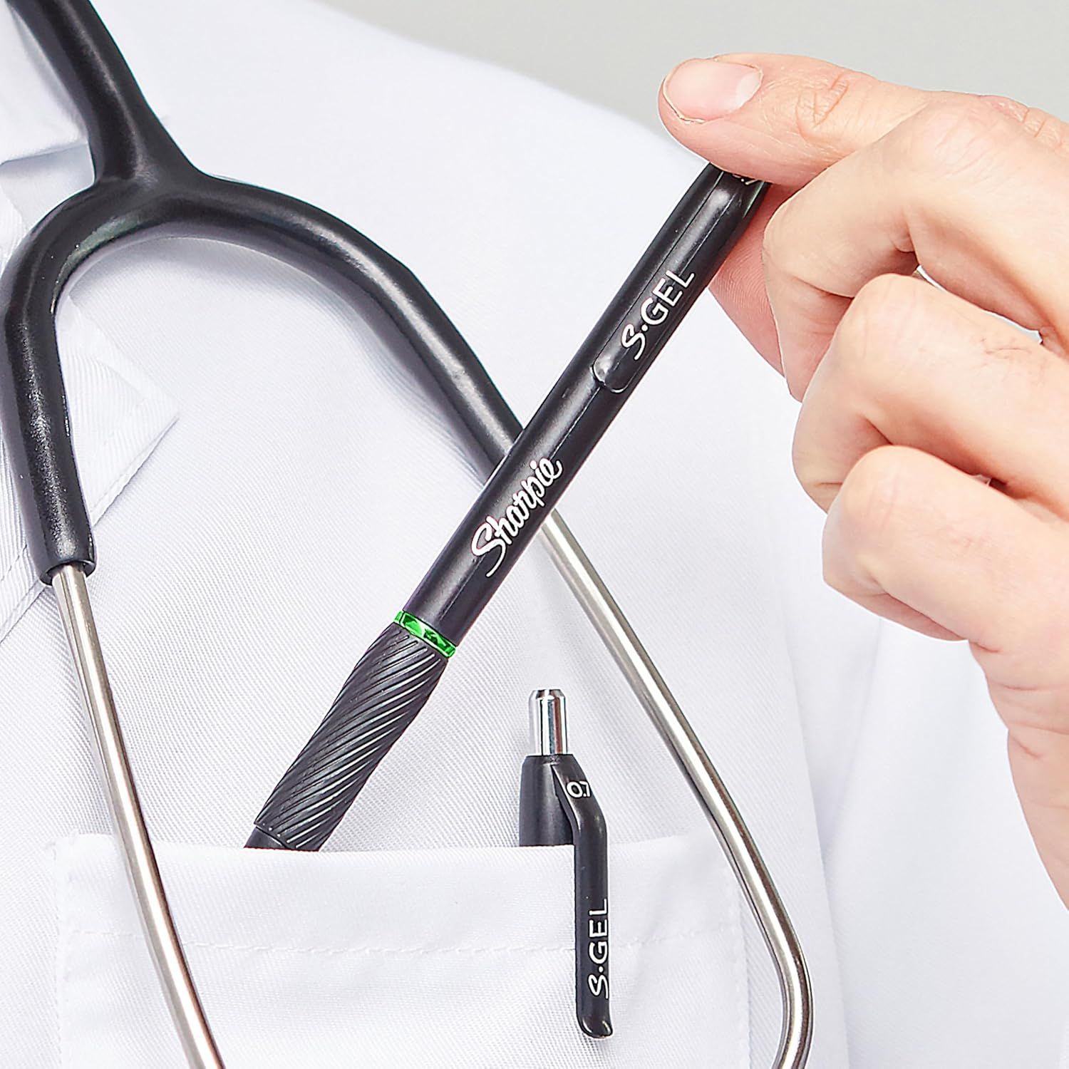 Demonstrates the product's compact size by showing it held in a hand next to everyday objects (pen and scissors), helping shoppers understand its portability and convenient dimensions.