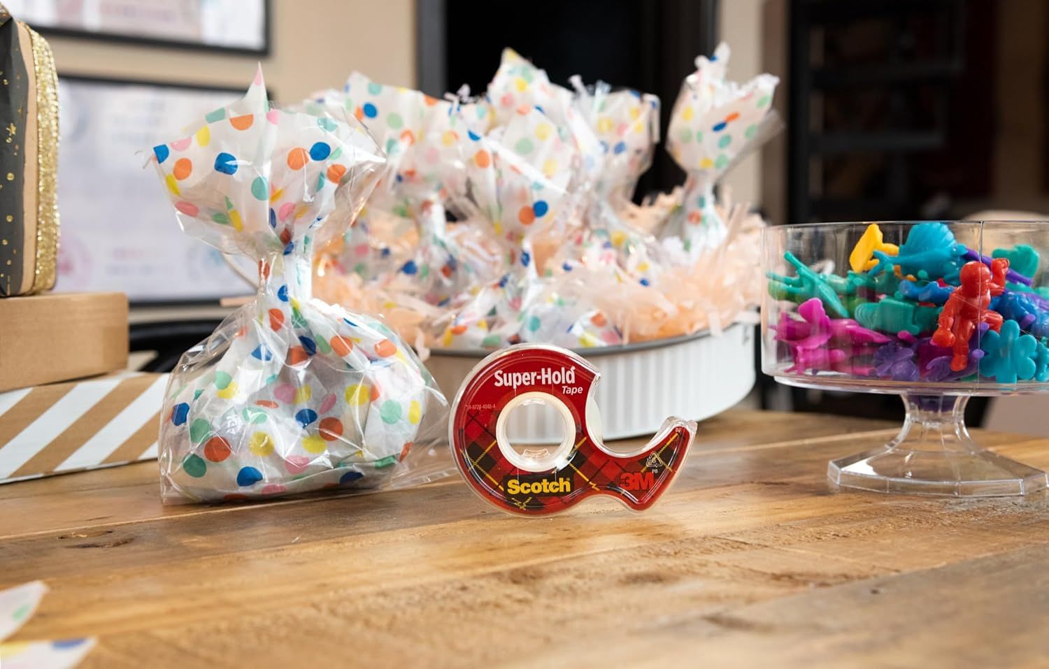 Shows the product in a real-world party or crafting context to help shoppers visualize how the tape fits into everyday creative and gift-wrapping scenarios.