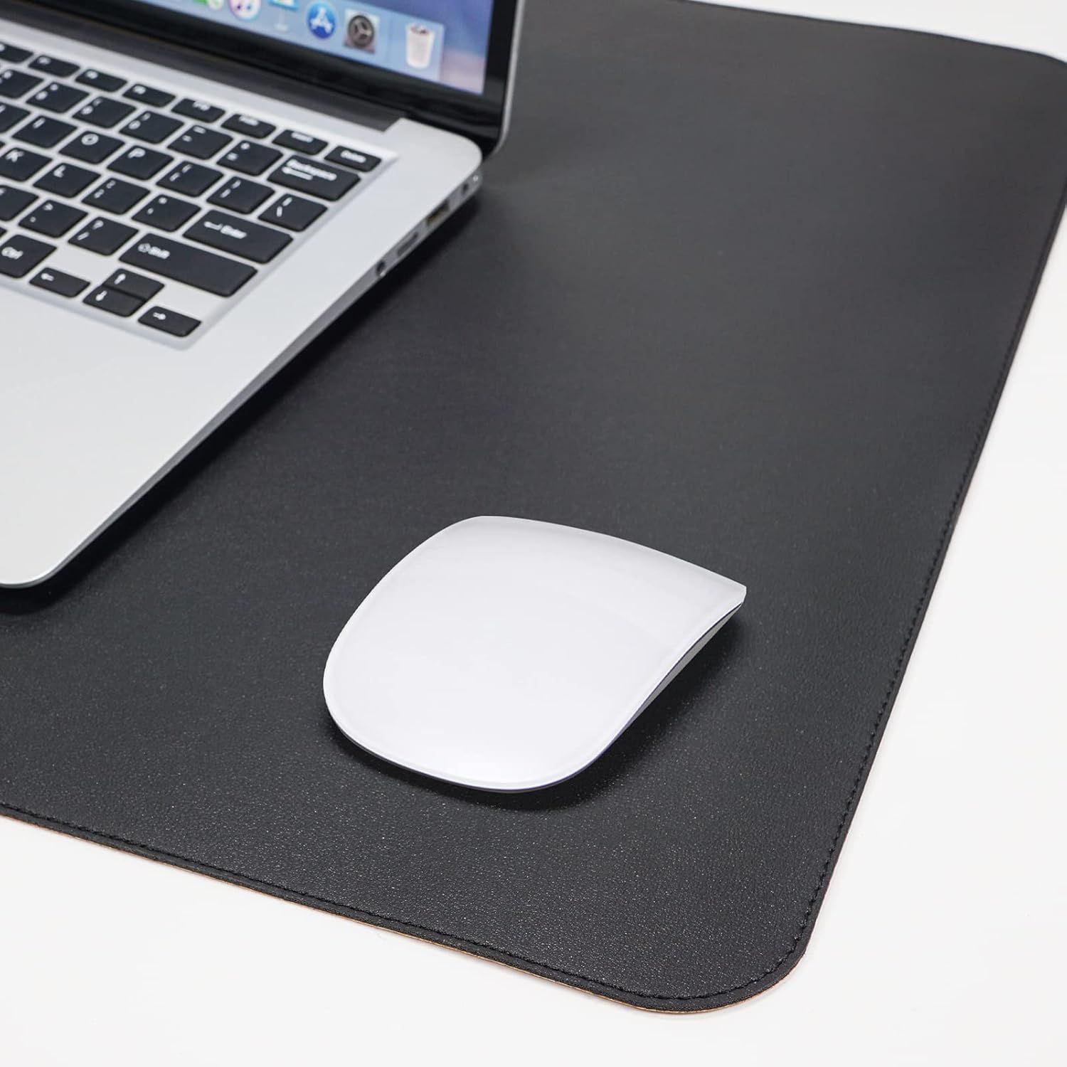 Shows the product (desk mat/mouse pad) in a real-world office or workspace setting with a laptop and mouse to help shoppers visualize how it fits into their daily work environment.