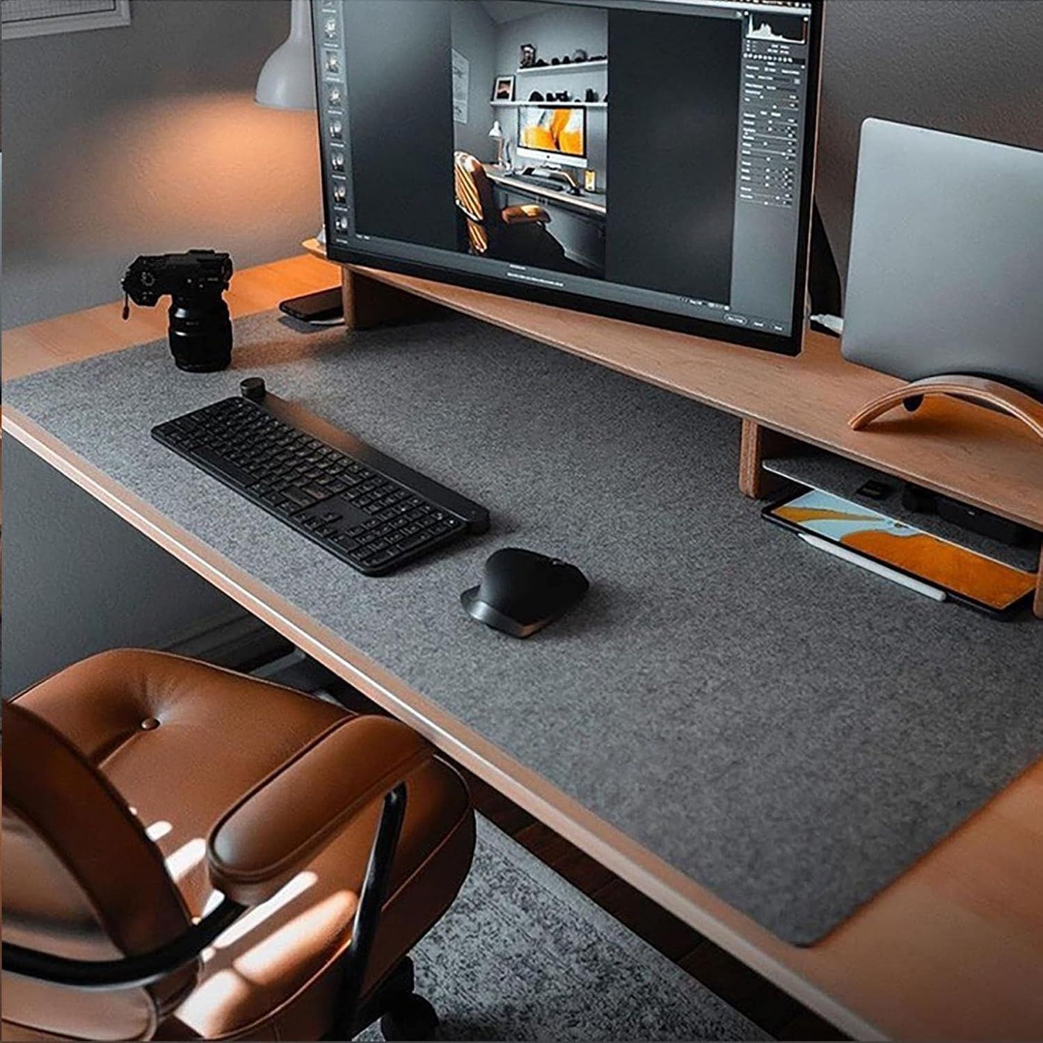 Showcases the product (desk mat/pad) in a real-world home office setting to help shoppers visualize how it fits into a modern, professional workspace.
