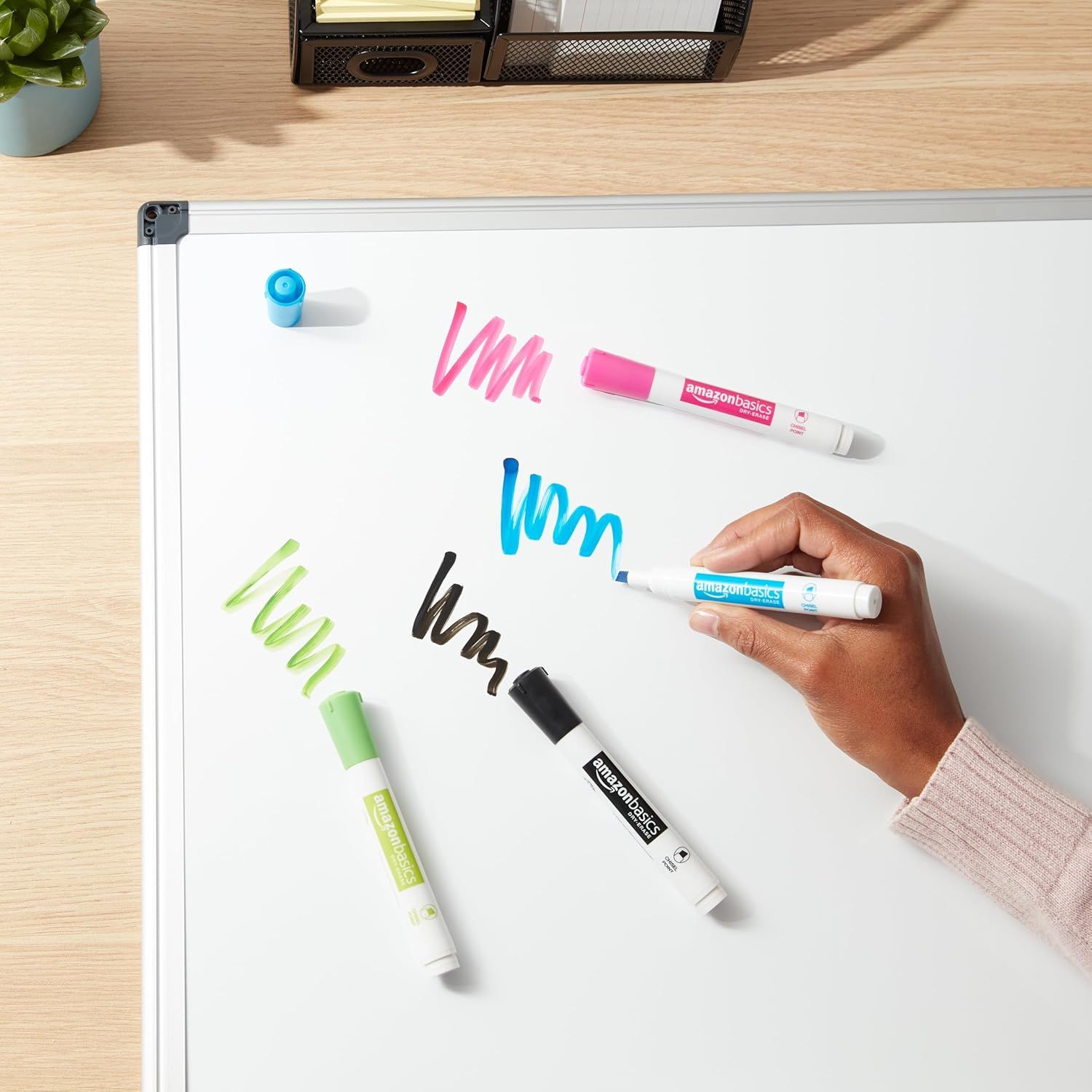 Shows the product being used in a real-world context on a whiteboard, demonstrating the markers' vibrant colors and practical application in an office or home environment.