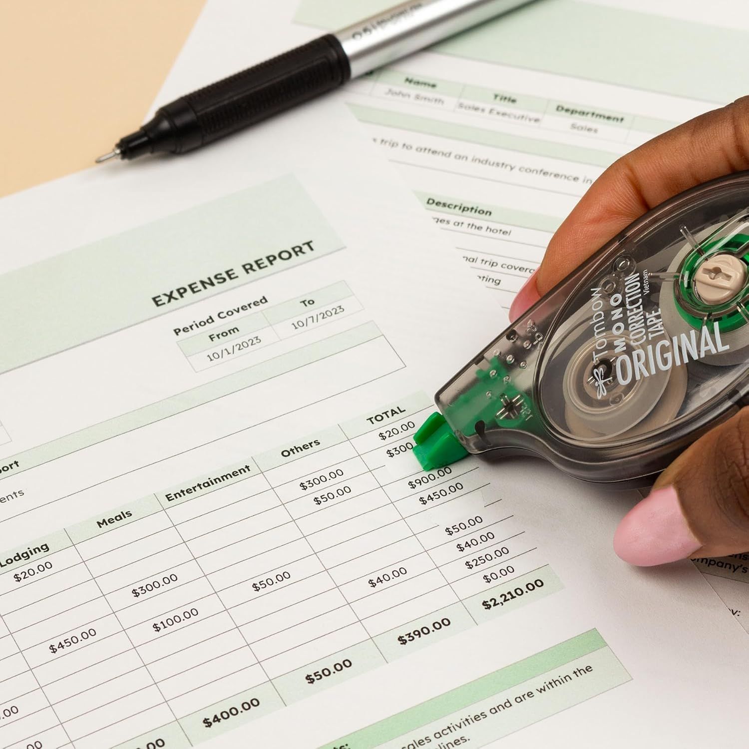 This is a clean product photograph showing office supplies (correction tape and pen) alongside an expense report document, demonstrating the product in a real-world office context.
