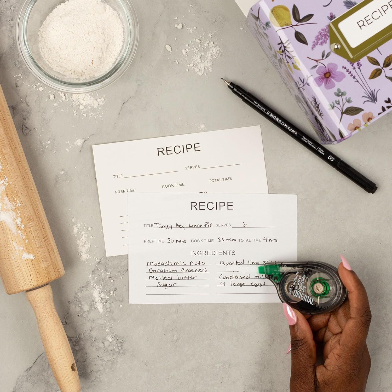 Demonstrates the product (recipe cards) in a real-world baking context to help shoppers visualize how they would use the cards in their own kitchen.