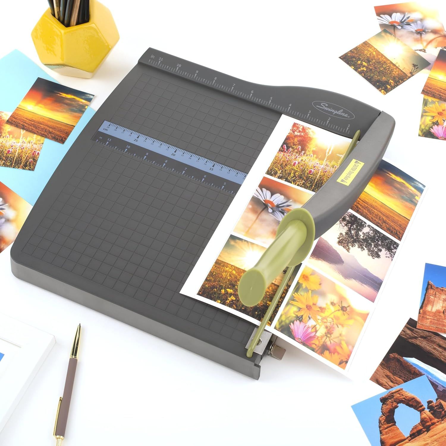 Demonstrates the product in a real-world crafting context, showing it being used to trim printed photos in a creative workspace setting.