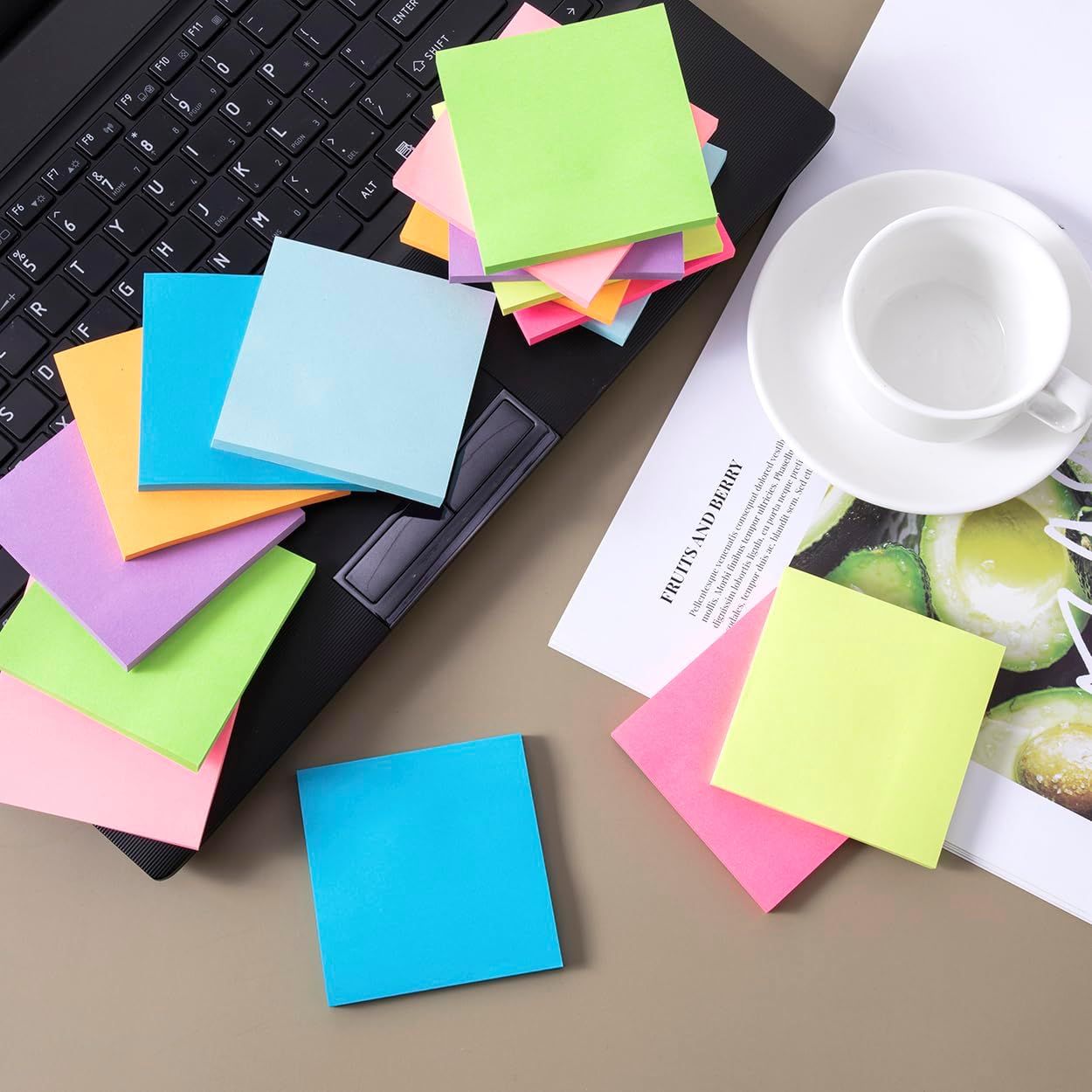 Shows the product (colorful sticky notes) in a clean, lifestyle setting to help shoppers visualize the variety of colors and sizes included in the pack.