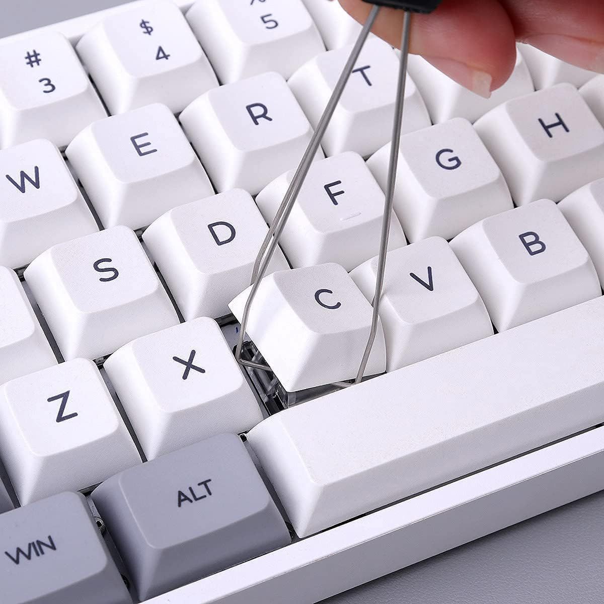 Demonstrates the keyboard's hot-swappable key feature, showing users they can easily remove and replace keys without tools for customization or maintenance.