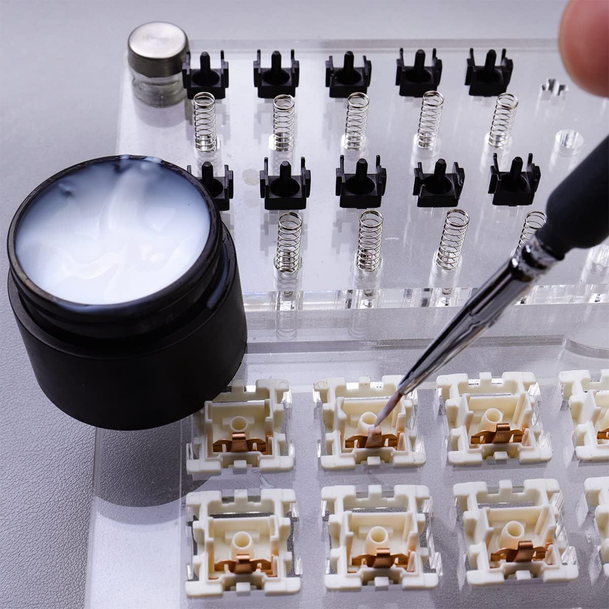 Shows all the components and tools included in the keyboard customization kit, helping shoppers understand the complete package they will receive for building or modifying mechanical keyboards.