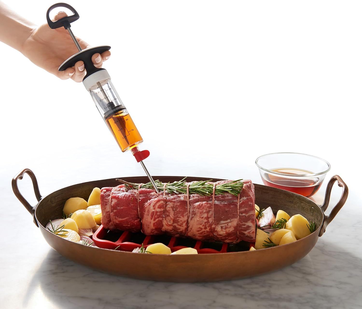 Demonstrates how to use the marinade injector to infuse flavor directly into meat, showing the product in action to help shoppers understand its practical application and ease of use. Highlights the…