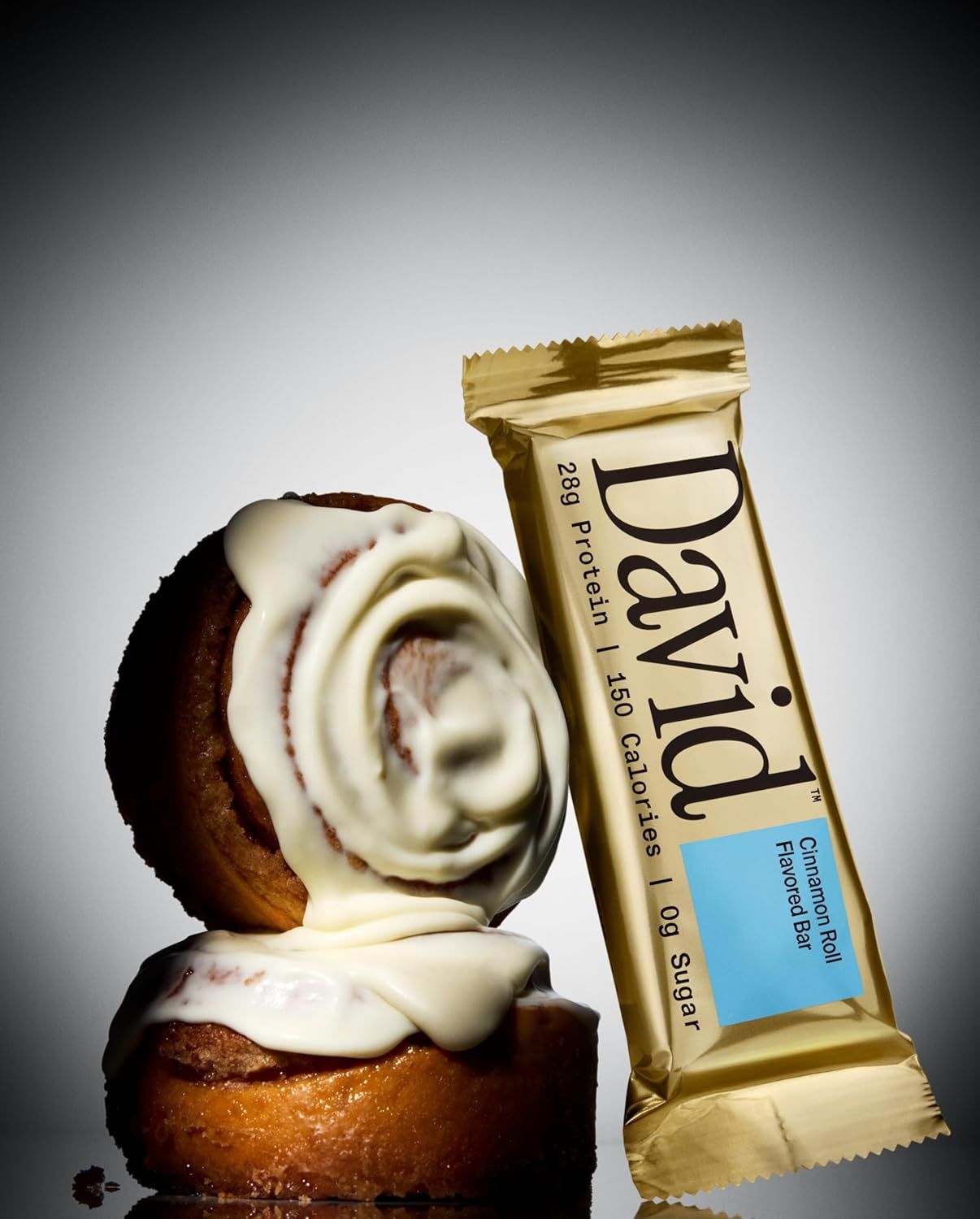 Provides a clean, catalog-style view of the protein bar product alongside cinnamon rolls to visually communicate the flavor profile and appeal to shoppers looking for a simple product presentation.