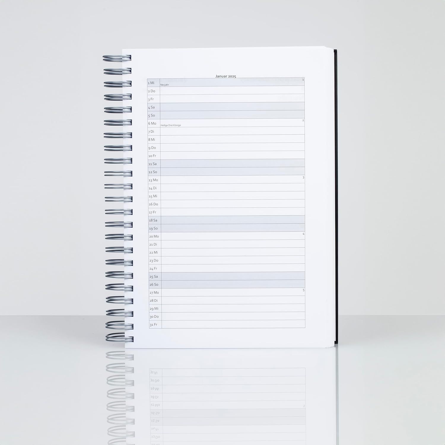 Displays the spiral-bound calendar/planner product on a clean white background to show the physical product clearly without distractions.