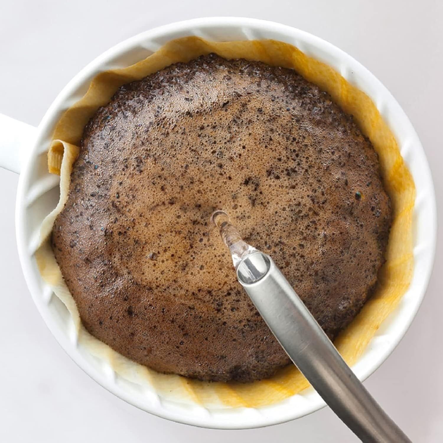 Demonstrates a step in the preparation or mixing process, showing shoppers how to use or prepare the product.