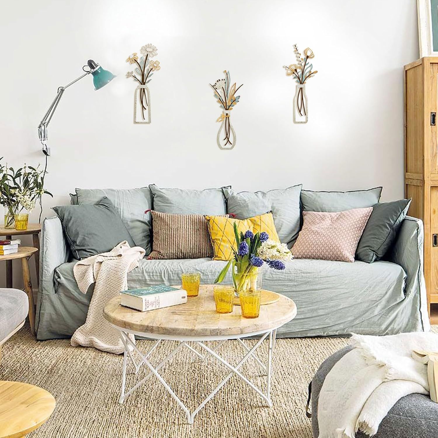 Displays the wall decor in a styled living room environment to help shoppers envision the product in their own space.