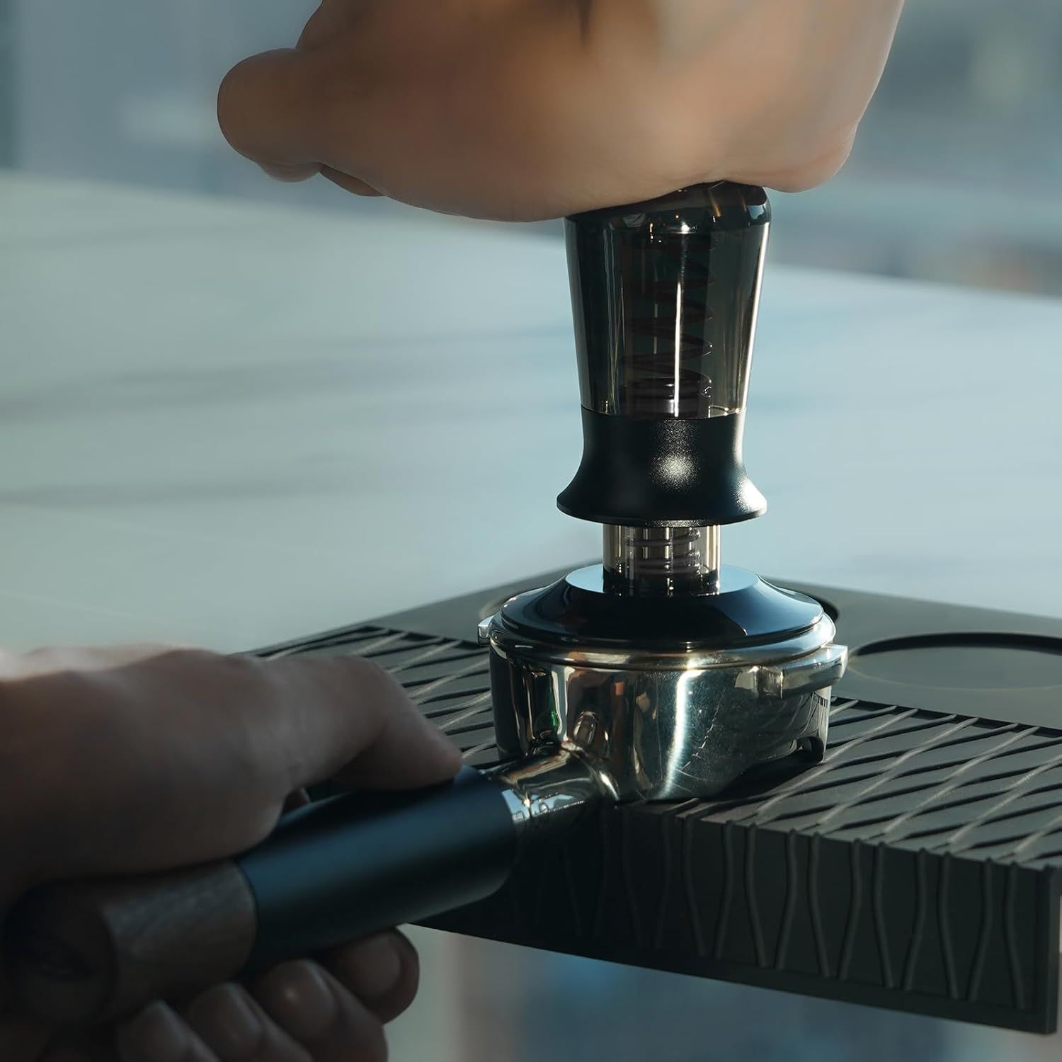 Demonstrates the hands-on process of using the tamper with an espresso machine, showing shoppers how easy it is to operate.