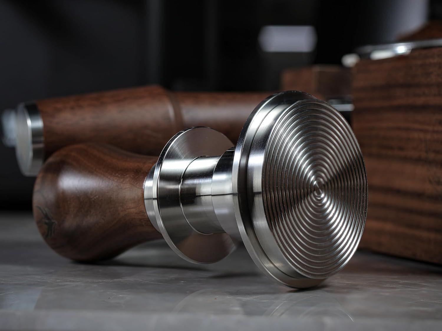 Showcases the high-quality materials and precision engineering of the tamper base through a close-up lifestyle shot with no text overlay.