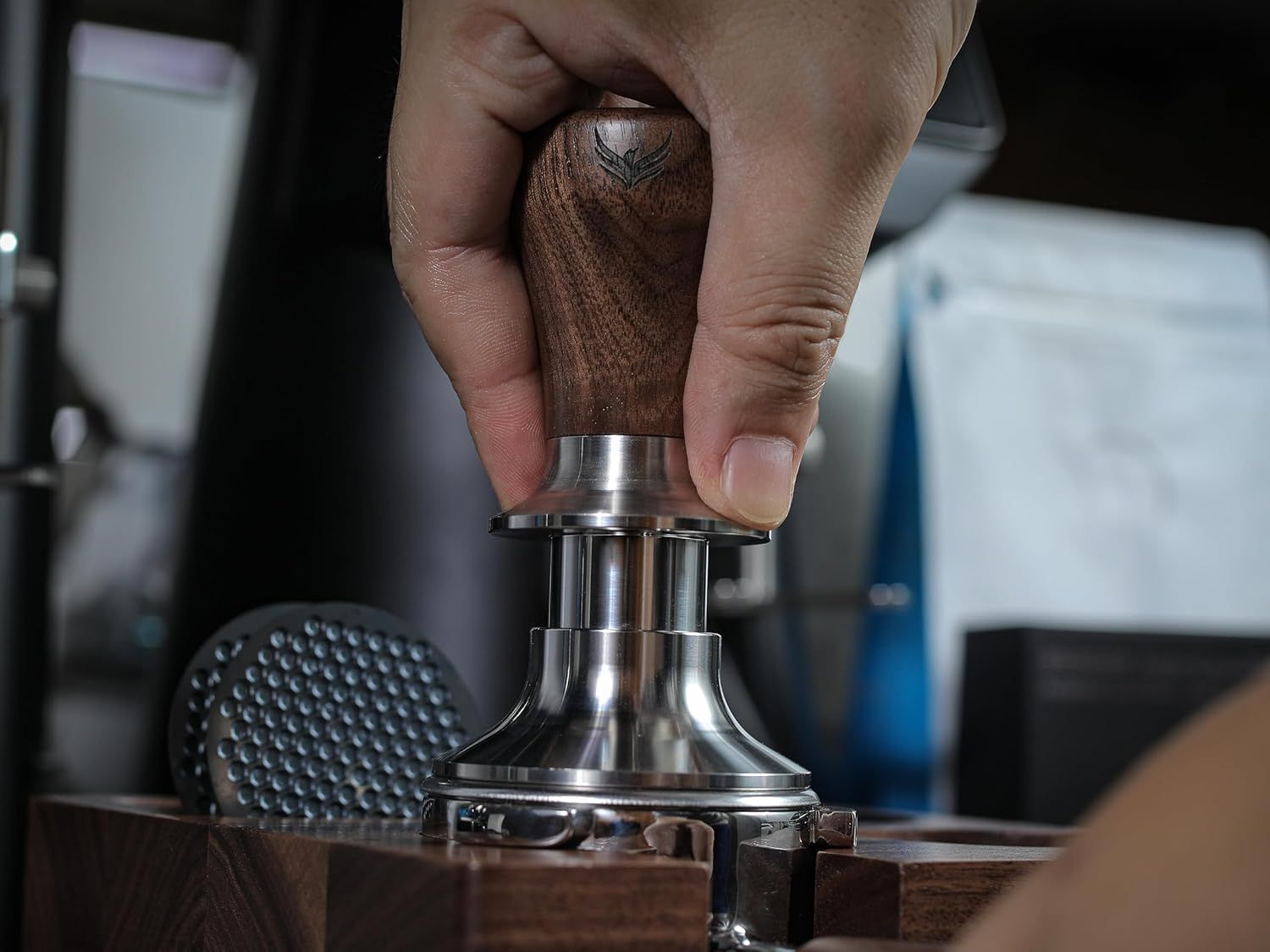 Shows the tamper being used in a real espresso-making scenario to help shoppers visualize the product in their own coffee routine.