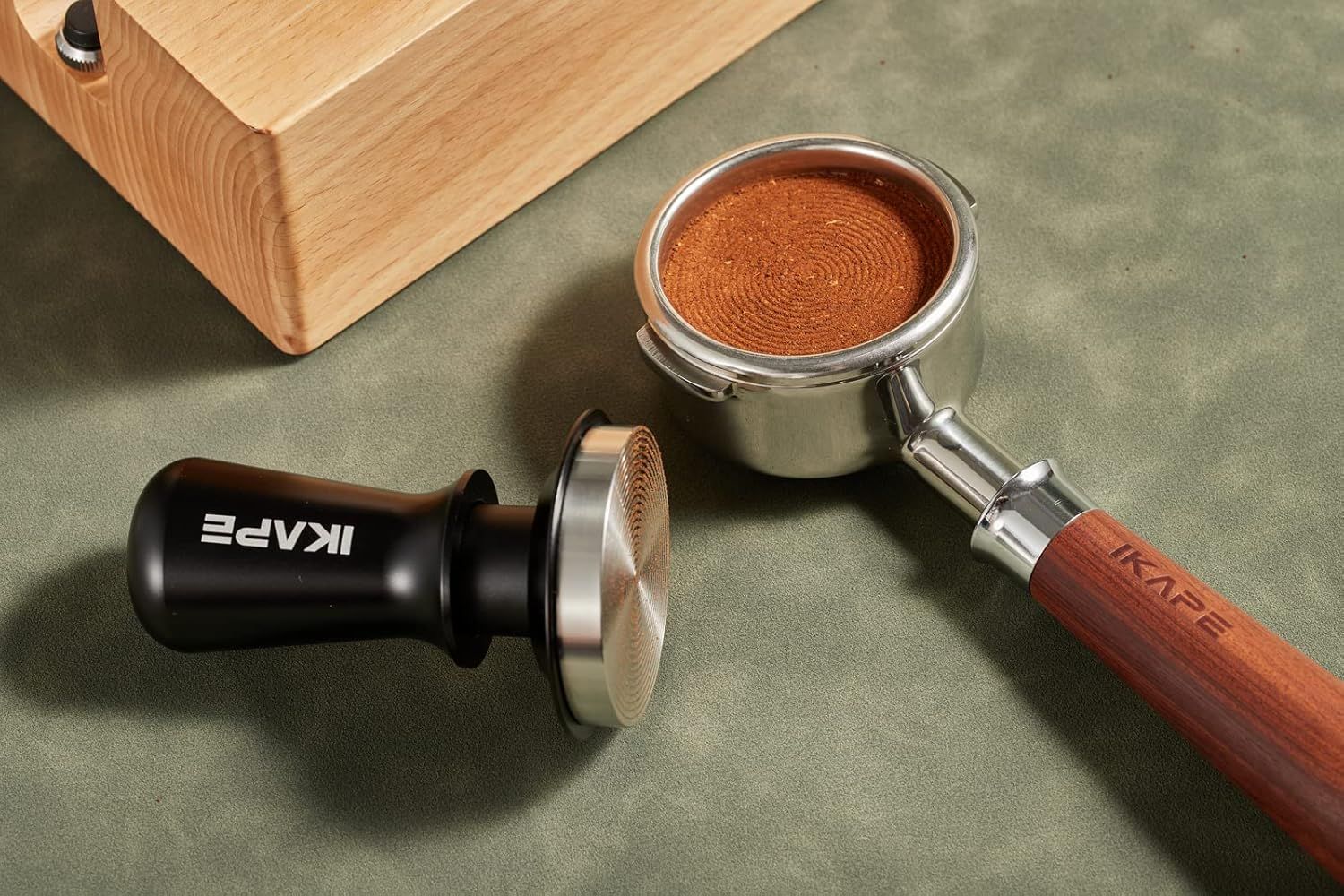 Shows the tamper and portafilter in a real-world coffee preparation setting to help shoppers visualize the product in use.