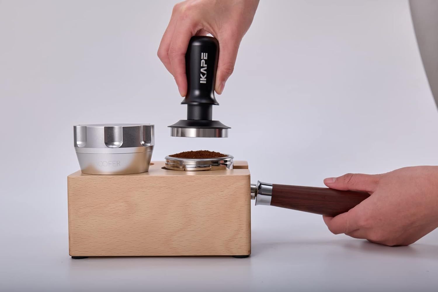 Illustrates the tamping process with the product in use on a tamping station, helping shoppers understand the product's practical application.