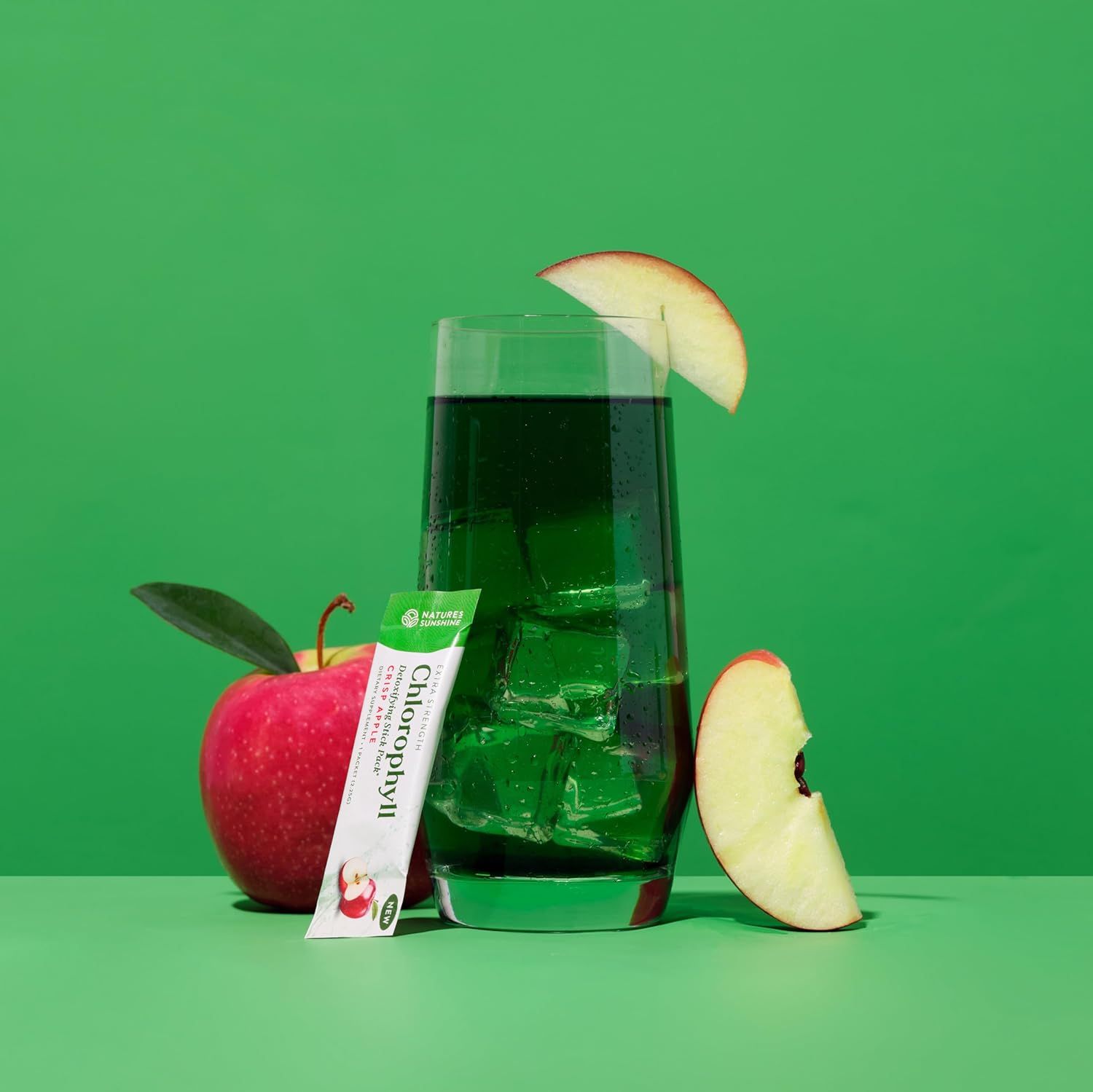 Shows the product mixed in a glass with ice and apple garnish in a lifestyle setting to demonstrate how the product looks when prepared and ready to consume.