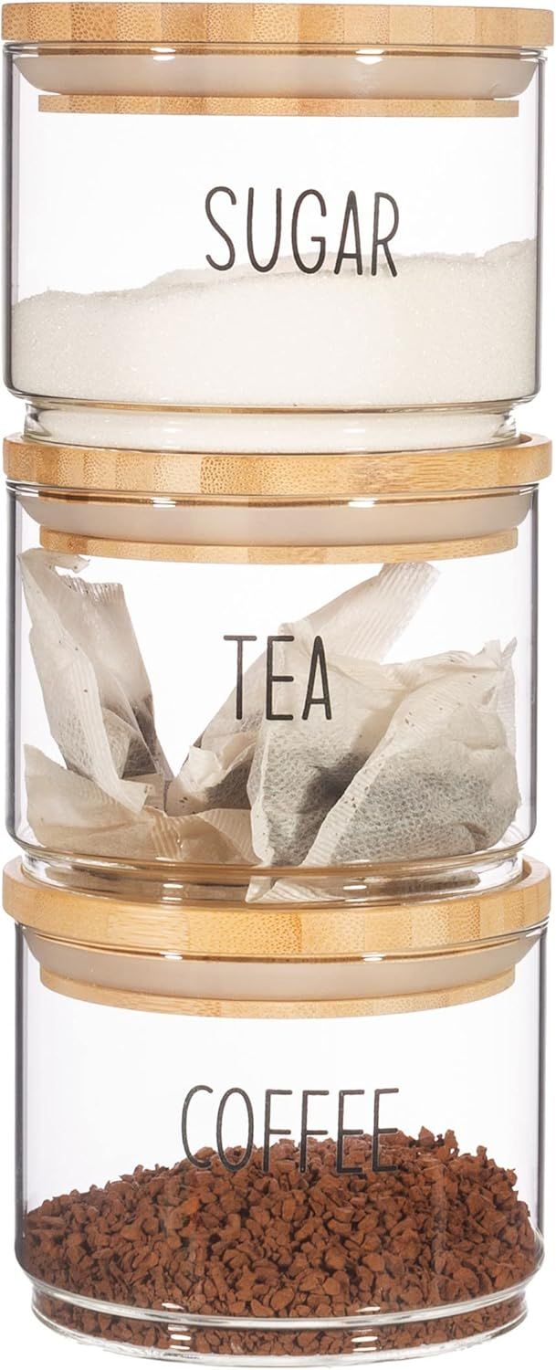 Shows the complete set of three stackable glass containers with bamboo lids labeled for sugar, tea, and coffee to demonstrate what the customer receives in the purchase.