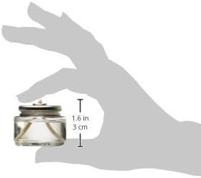 Shows the physical size of the candle using a hand as a reference object to help shoppers understand how compact the product is.