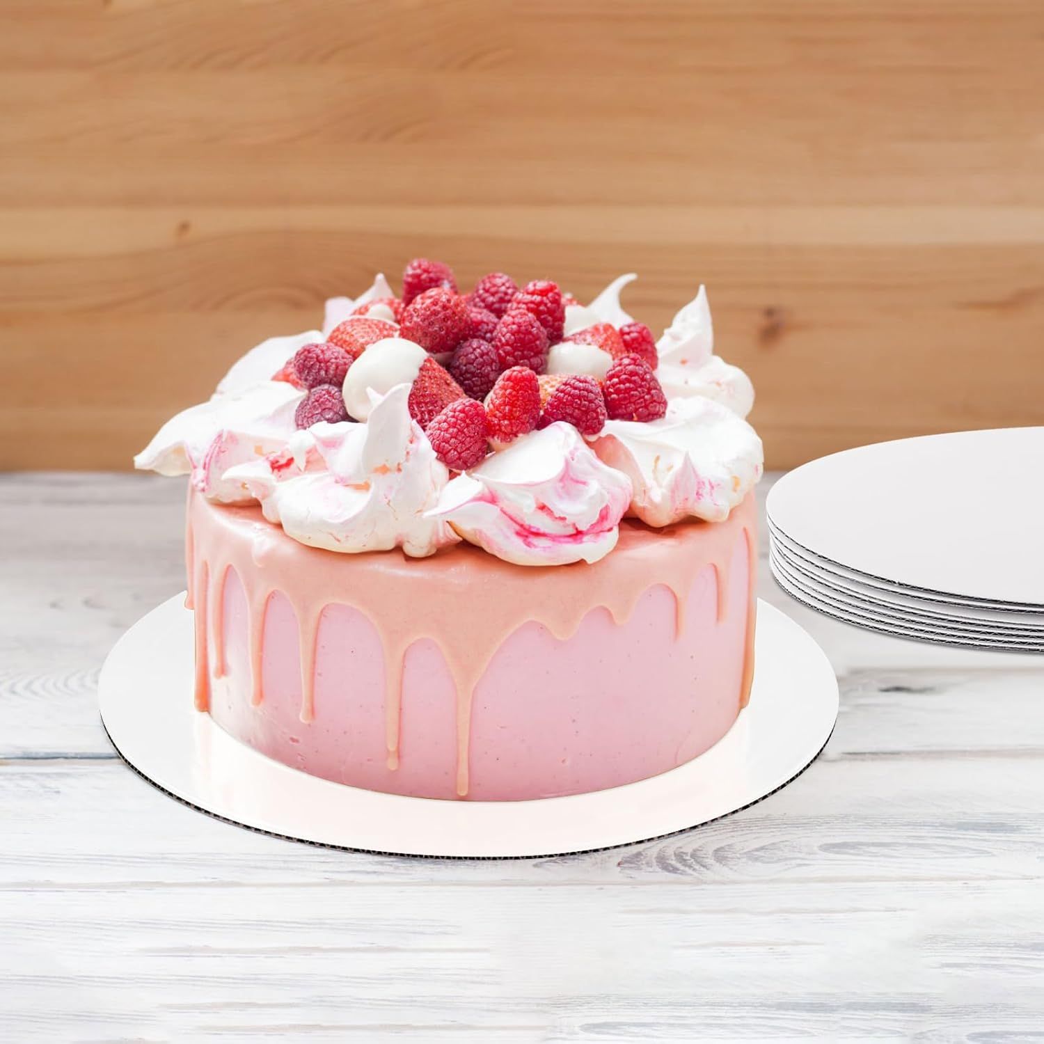 Shows the product in use in a real kitchen setting, helping shoppers visualize how the cake boards look when supporting an actual decorated cake.