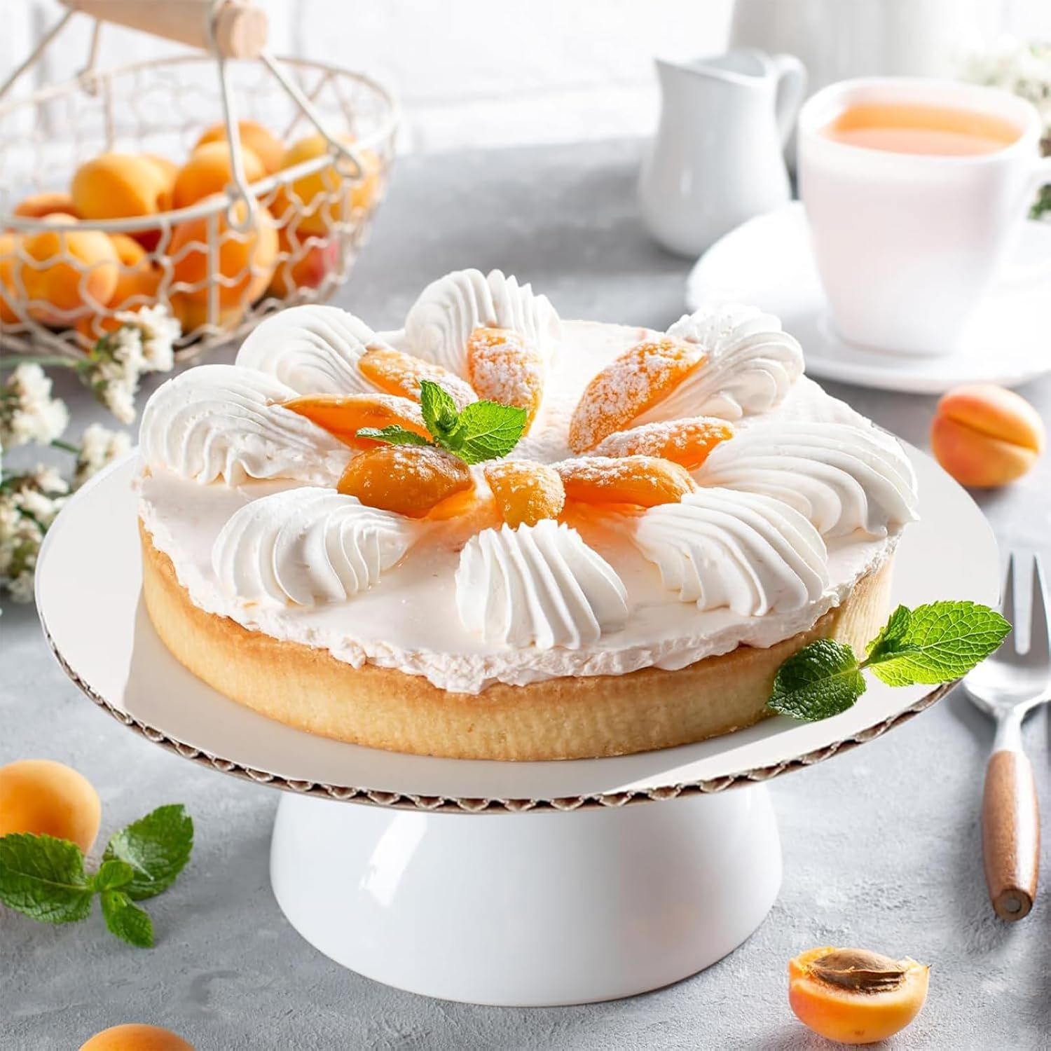 Shows the cake board in an attractive lifestyle context with a beautifully decorated cake to inspire shoppers and demonstrate real-world use.