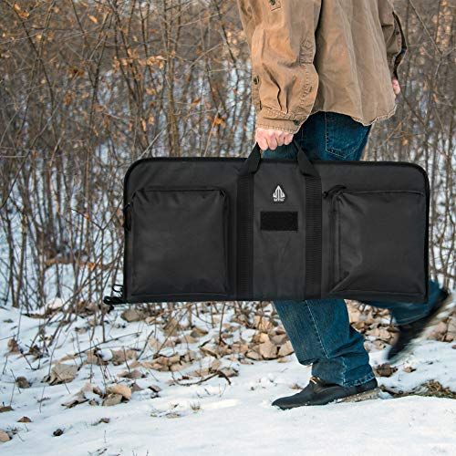Shows the tool bag being carried in a real-world outdoor setting to demonstrate its portability and practical use in field conditions.