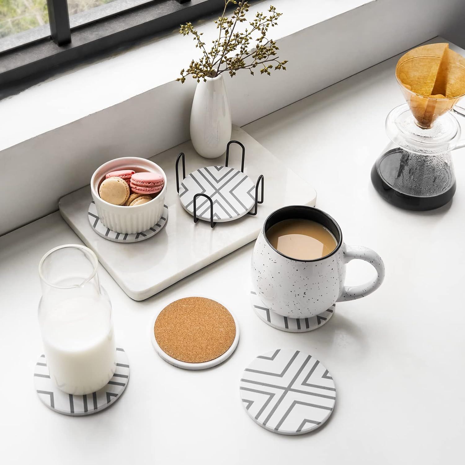 Displays the coasters in a styled home environment with various beverages and decorative items to show versatility and aesthetic appeal.
