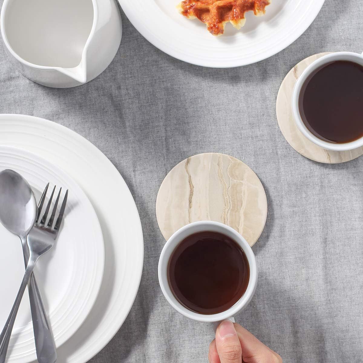 Demonstrates the coasters in use during a meal setting to show practical everyday application.