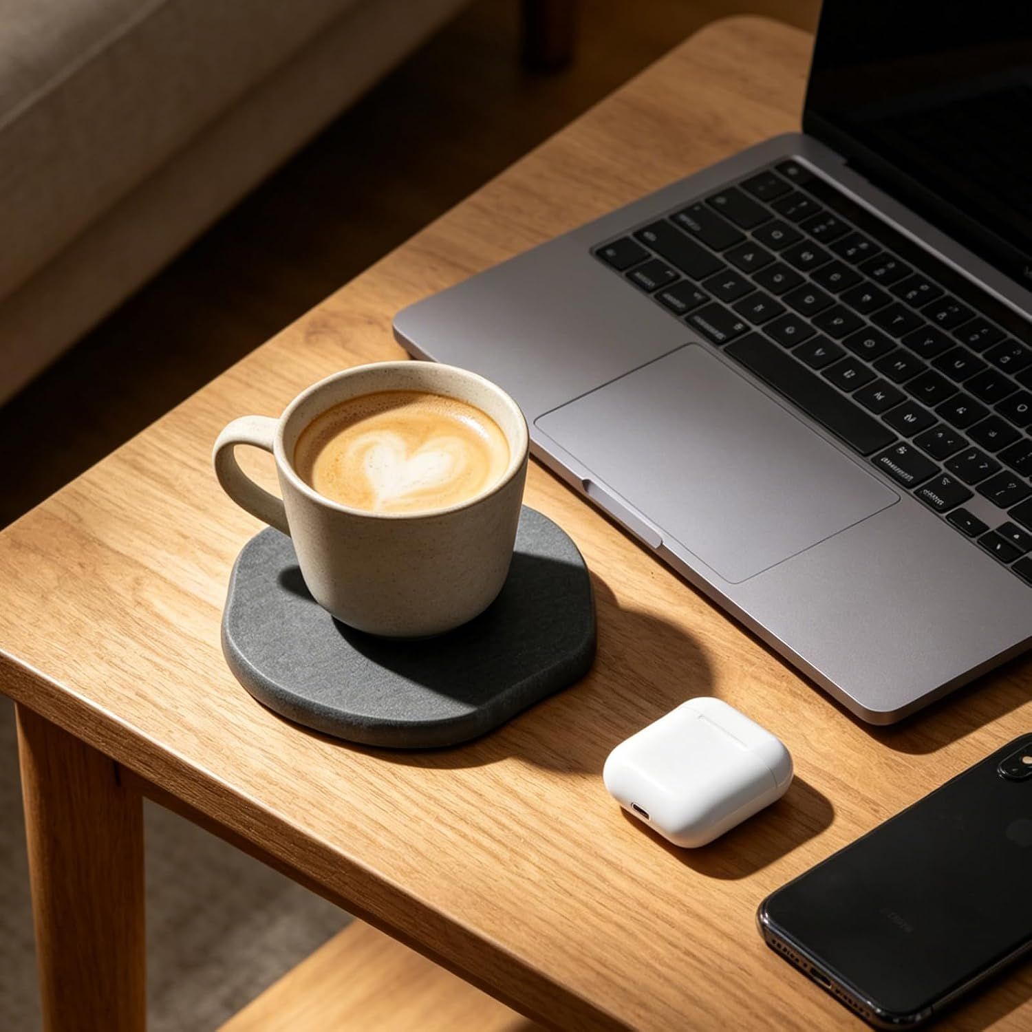 Displays the coaster in a work setting with a laptop and coffee, helping shoppers envision using it at their desk or workspace.
