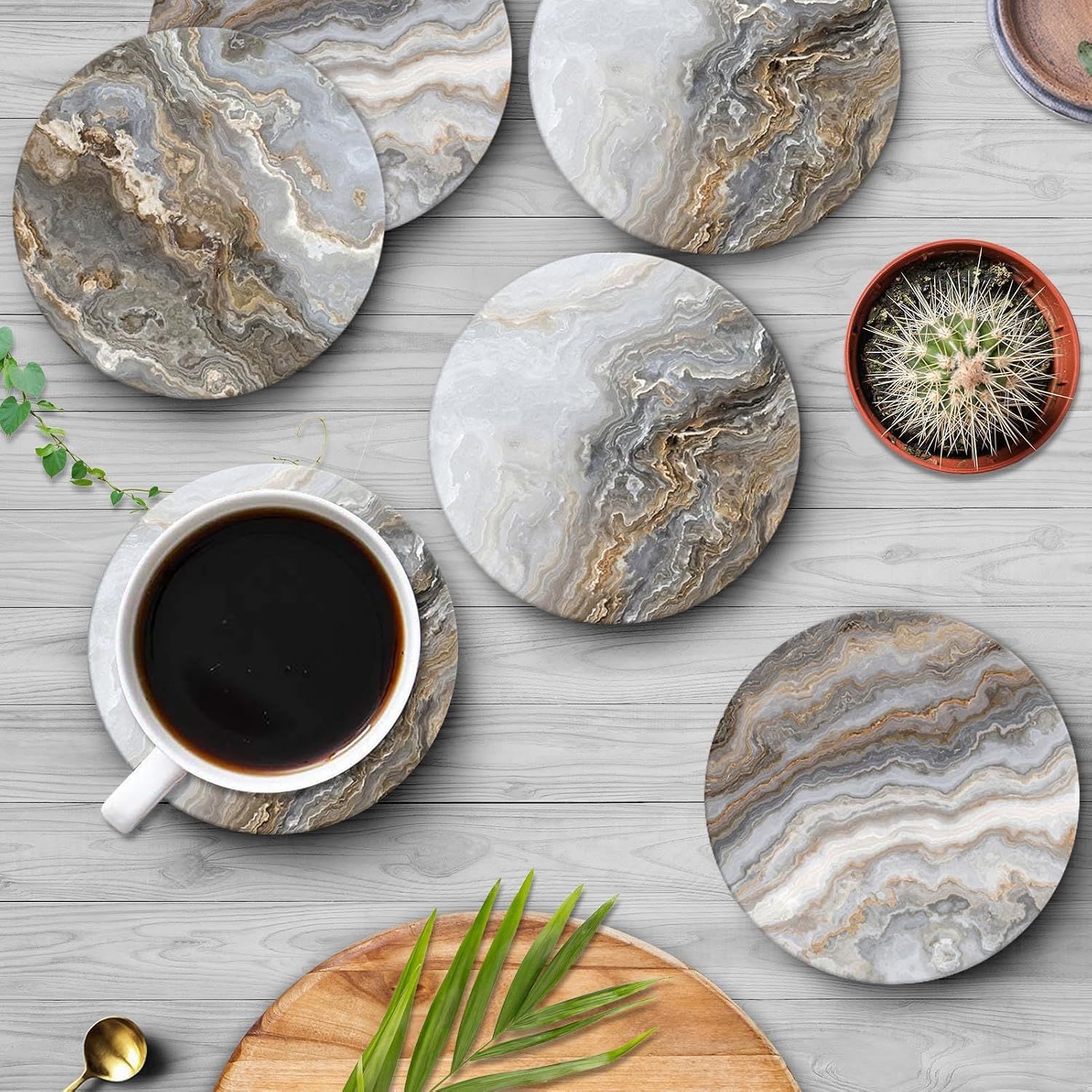 Shows the coasters in a real-world home setting with coffee and decor to help shoppers visualize the product in their own space.