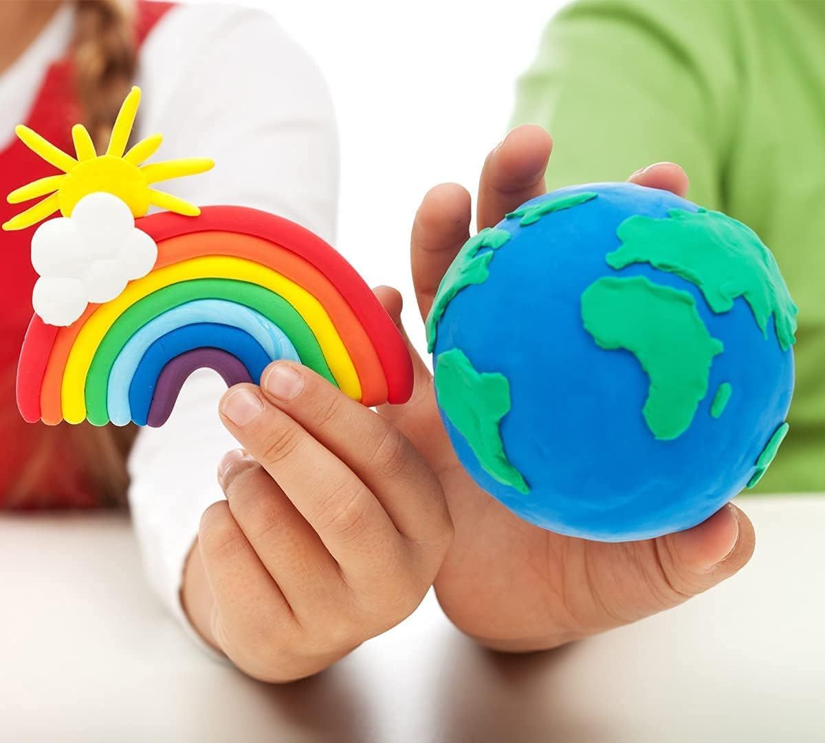 Shows hands holding finished clay creations to demonstrate the product's creative potential and appeal to parents and children.