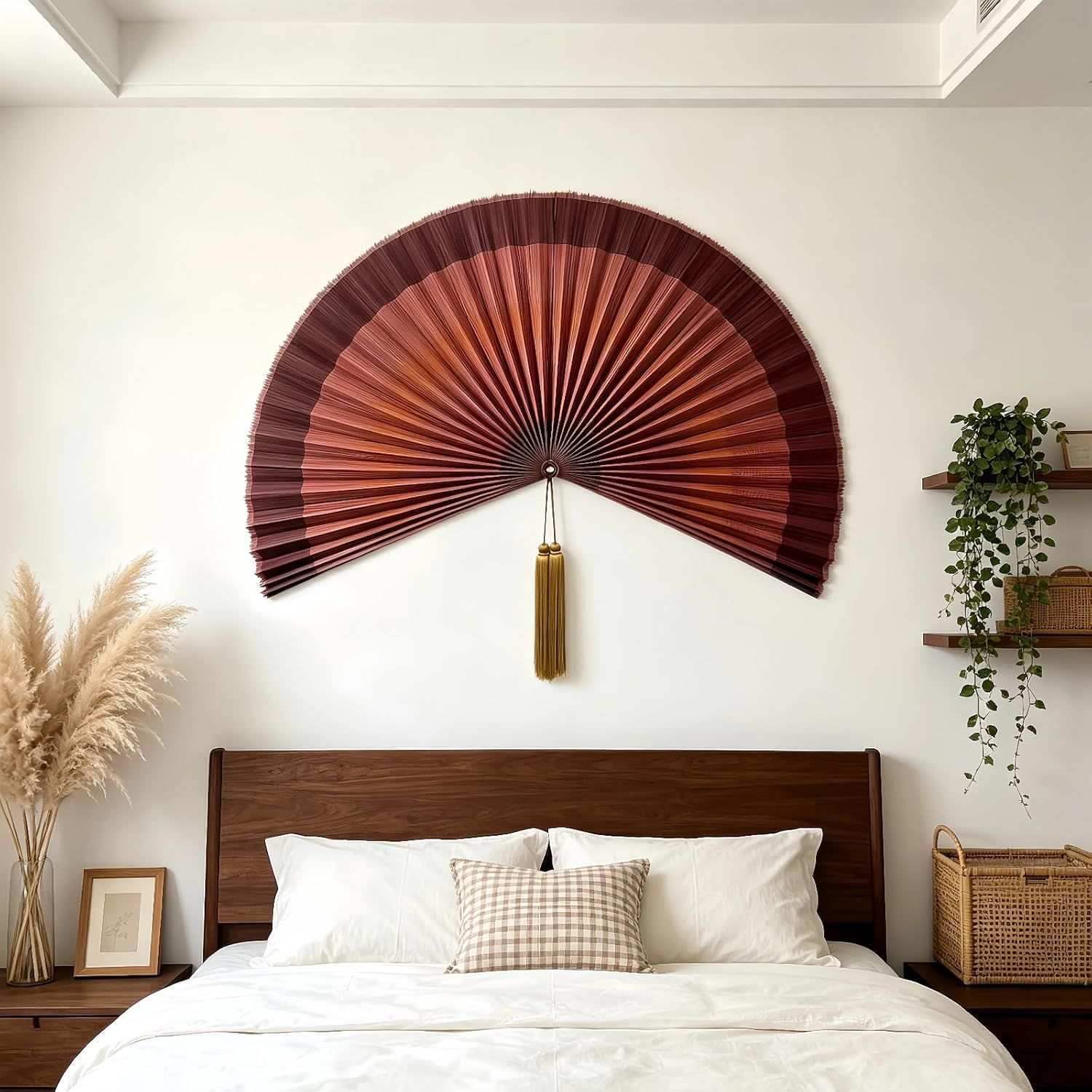 Shows the decorative fan displayed in a real bedroom setting to help shoppers visualize how the product looks as wall art in their own home.