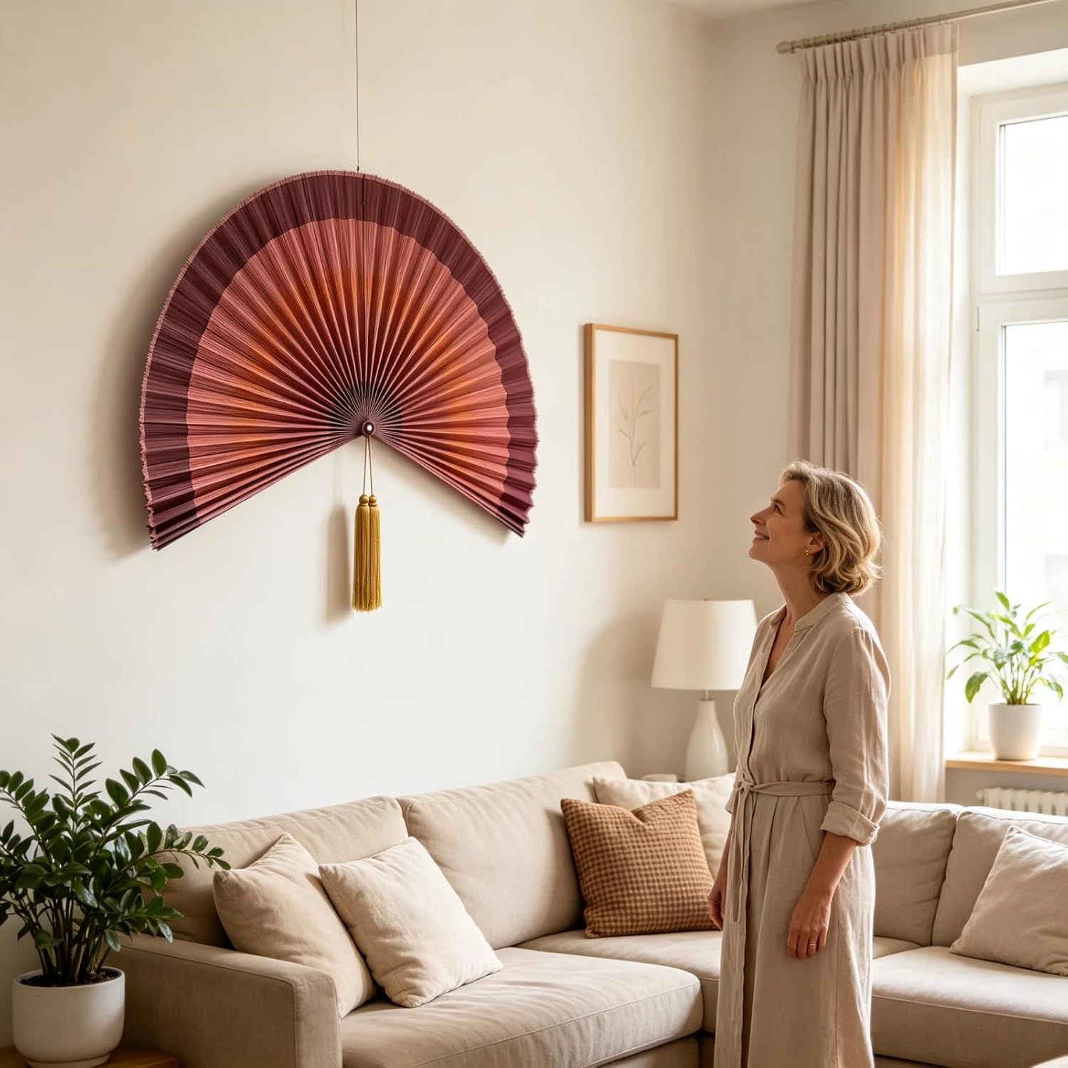 Shows the decorative fan in a living room with a person for scale, helping shoppers understand the size and visual impact of the product in a real home environment.